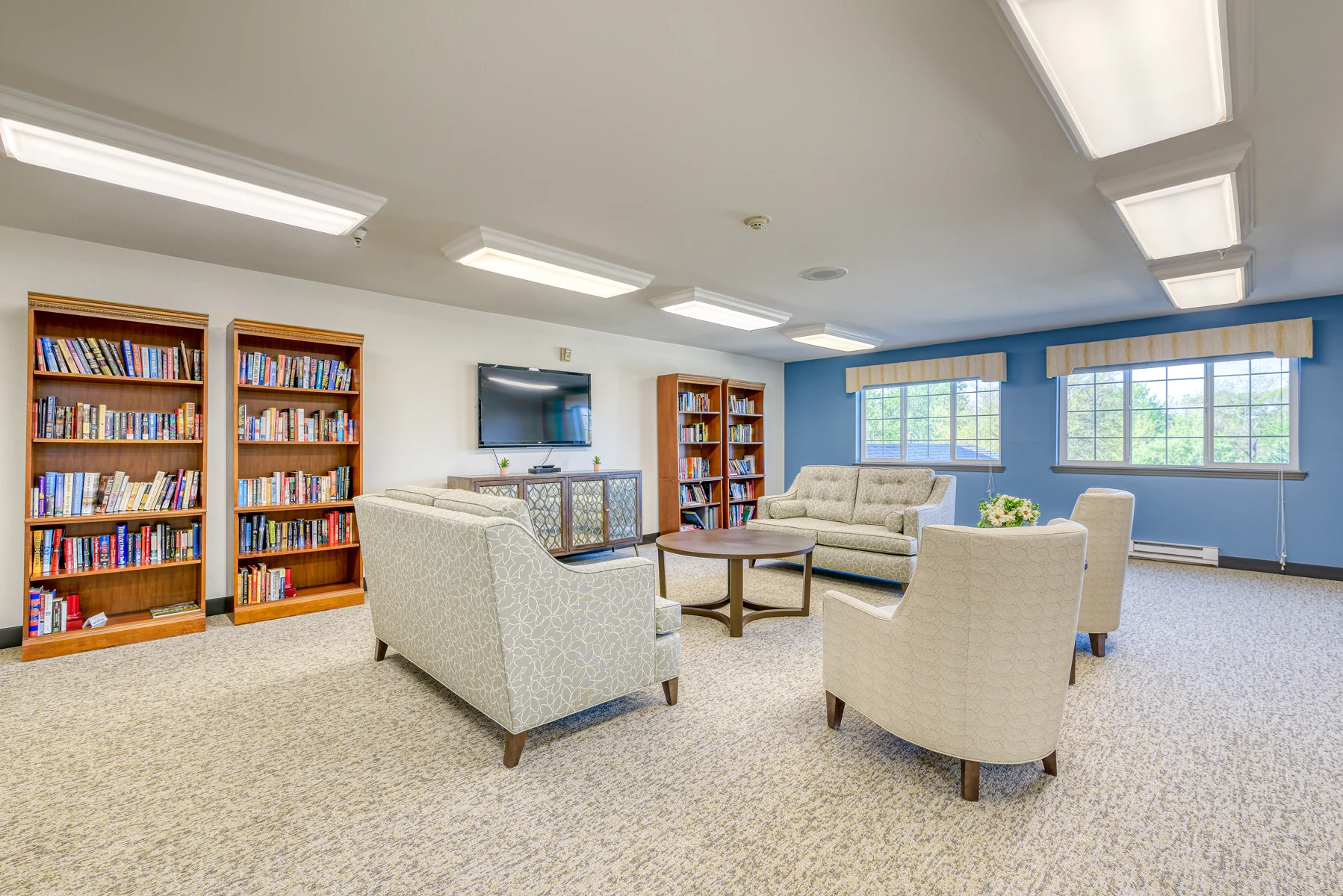 Bright common area with seating and bookshelves