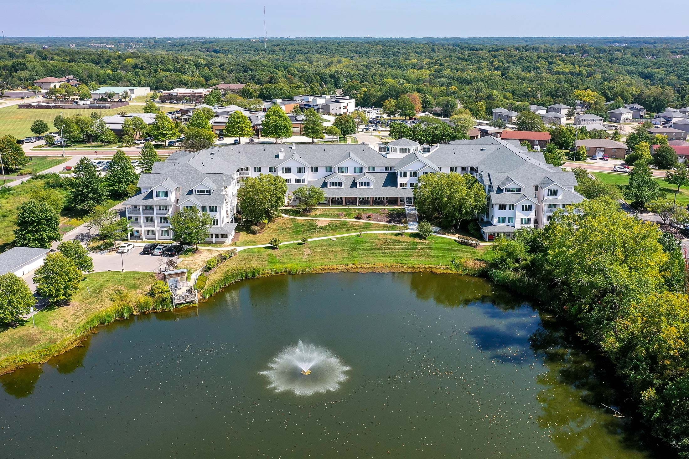 Aerial view of Solstice Senior Living at Columbia by a serene pond