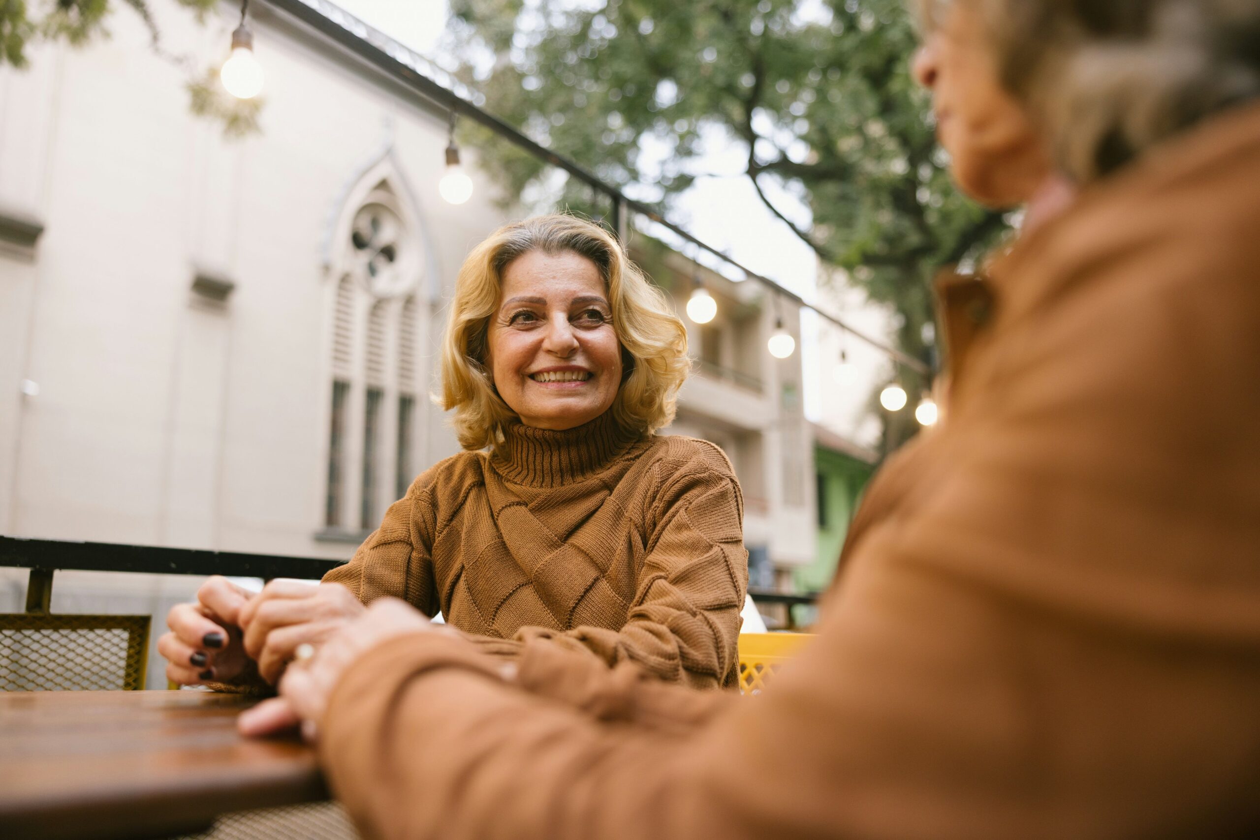 Two women enjoying conversation in an outdoor setting