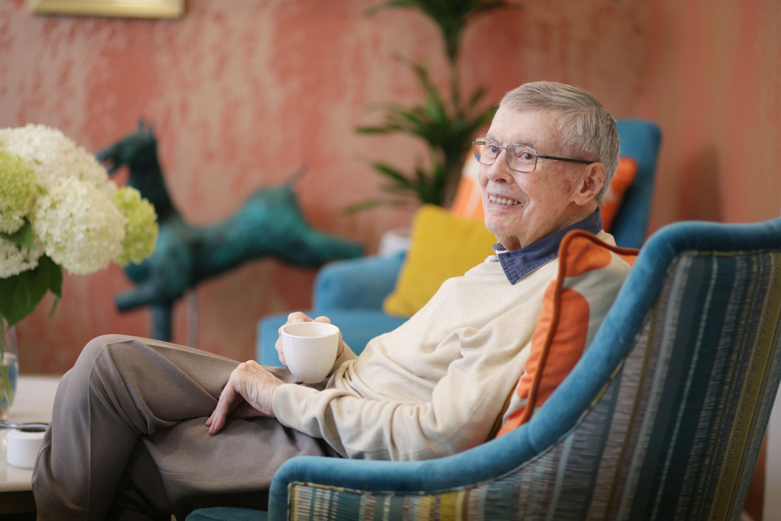 Senior resident enjoying a moment in a cozy lounge area