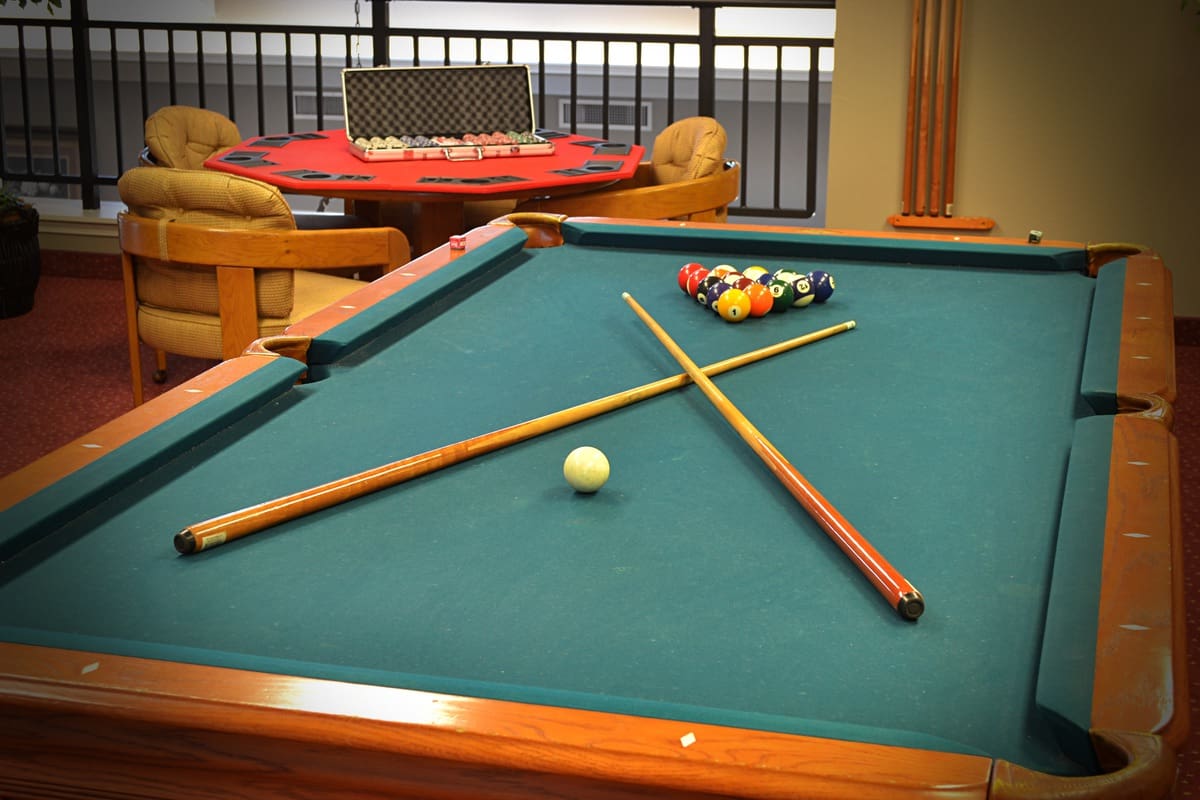 Pool table set up for a game in a common area