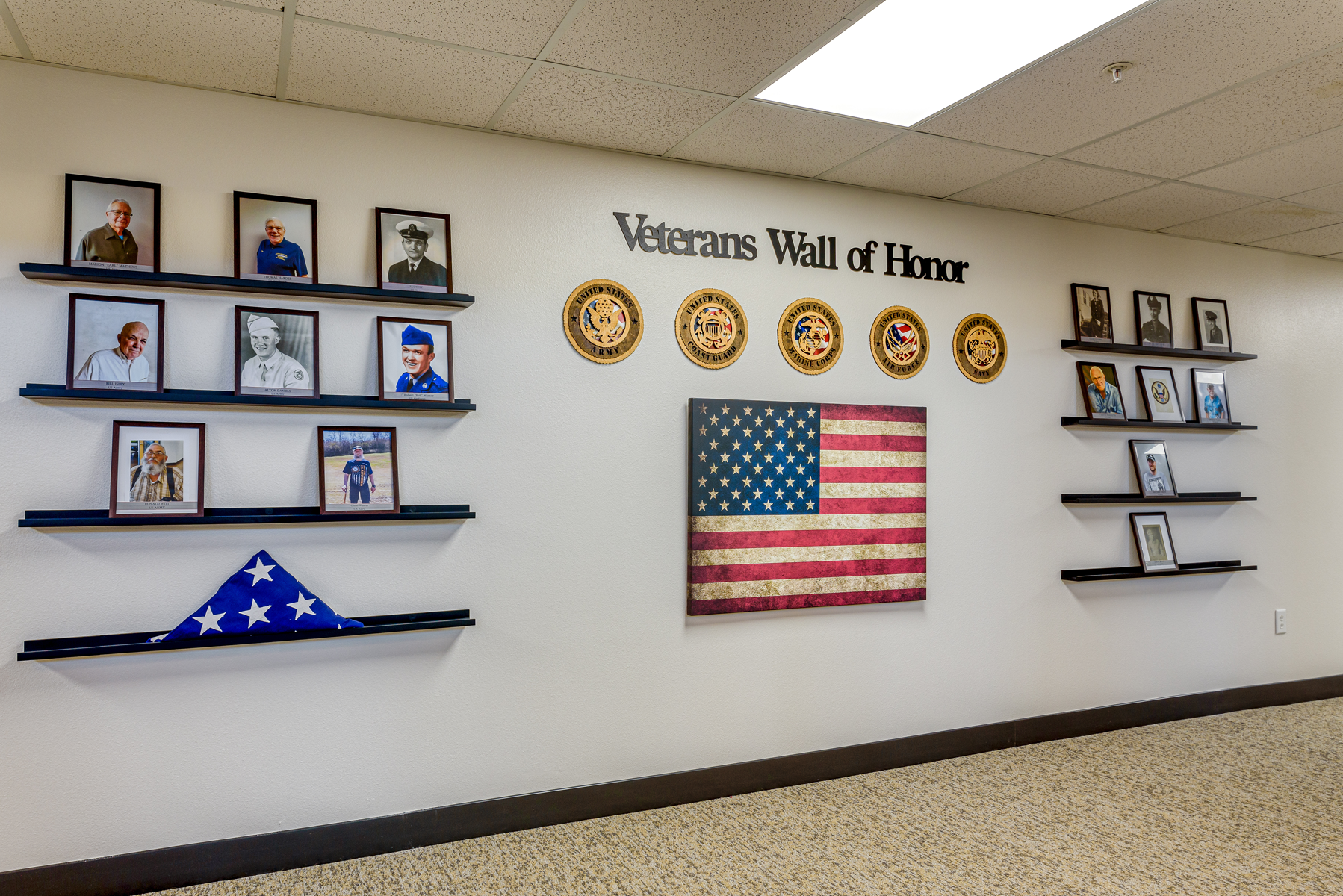 Veterans Wall of Honor with photos and flags