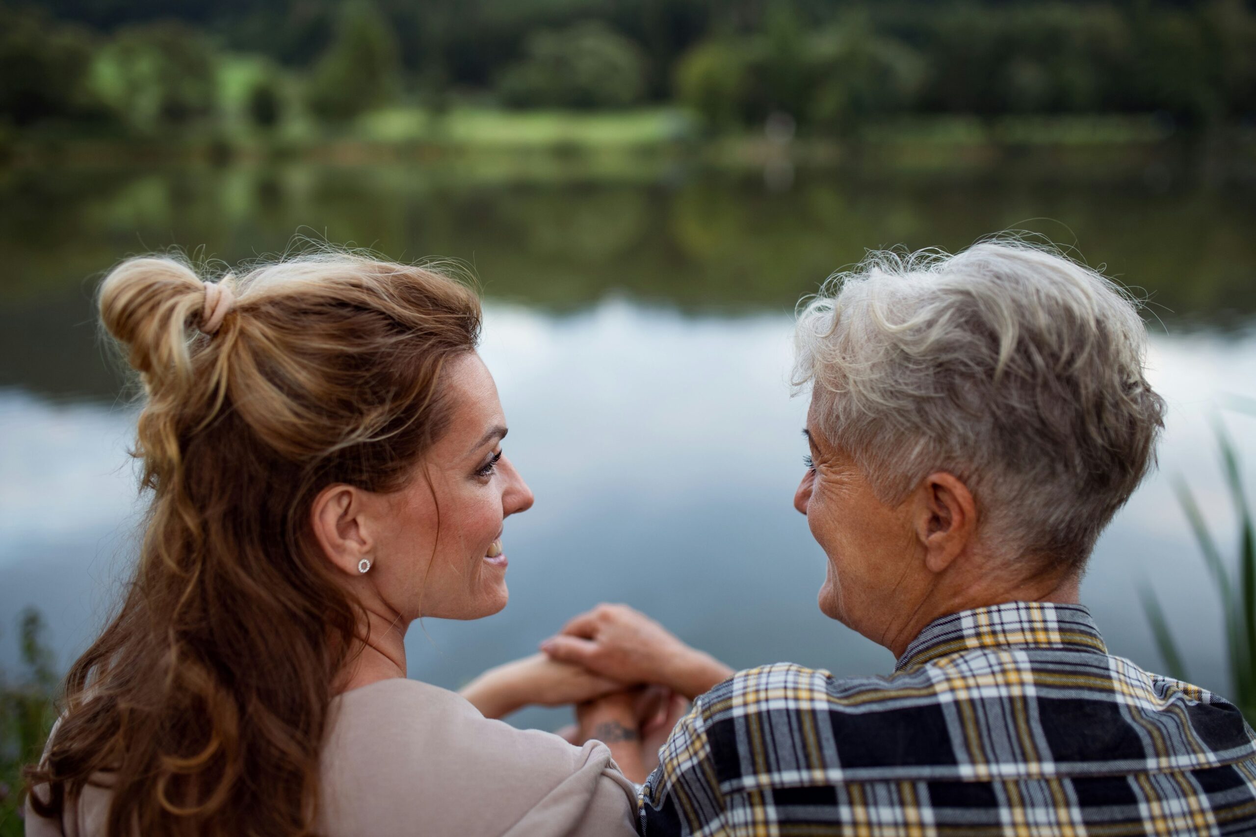 Two residents by a serene lake enjoying nature