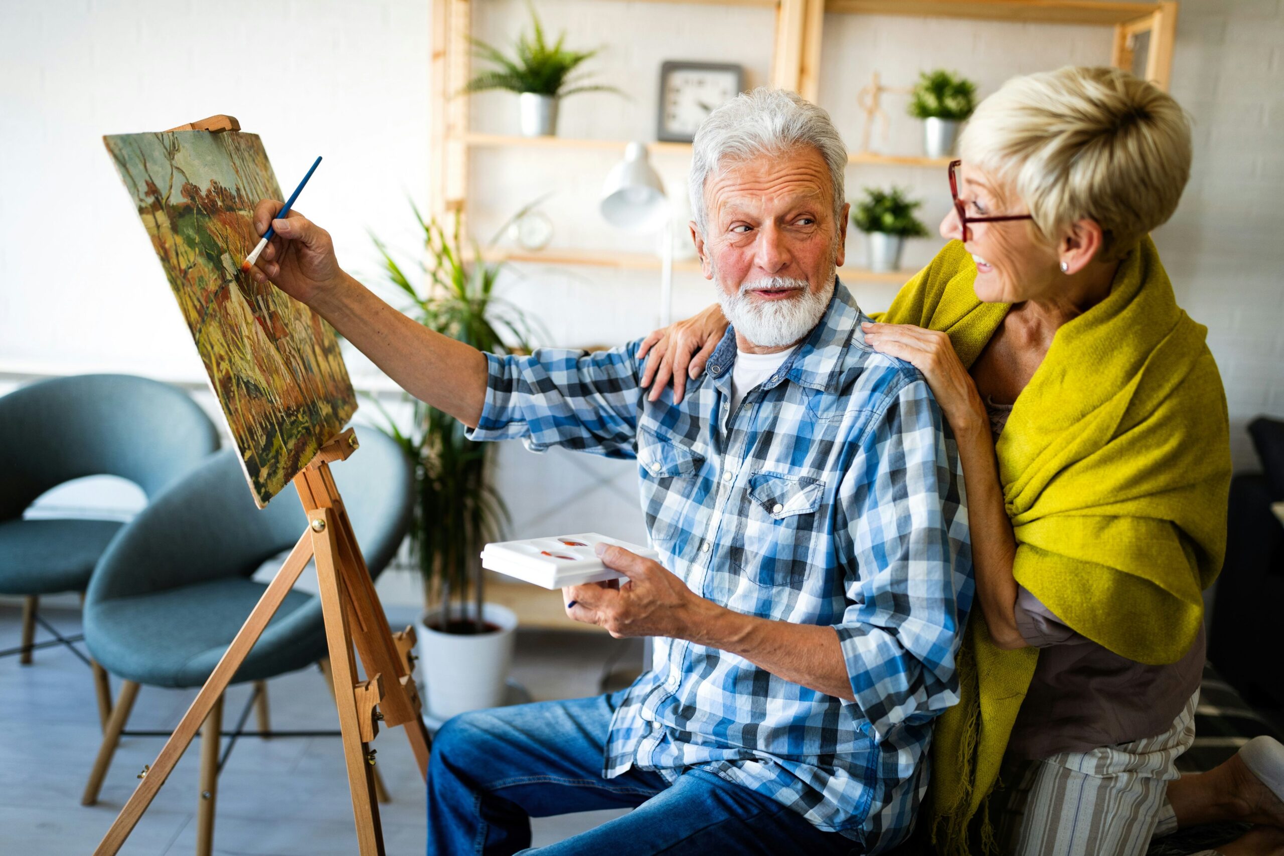 Residents engaged in a painting activity indoors