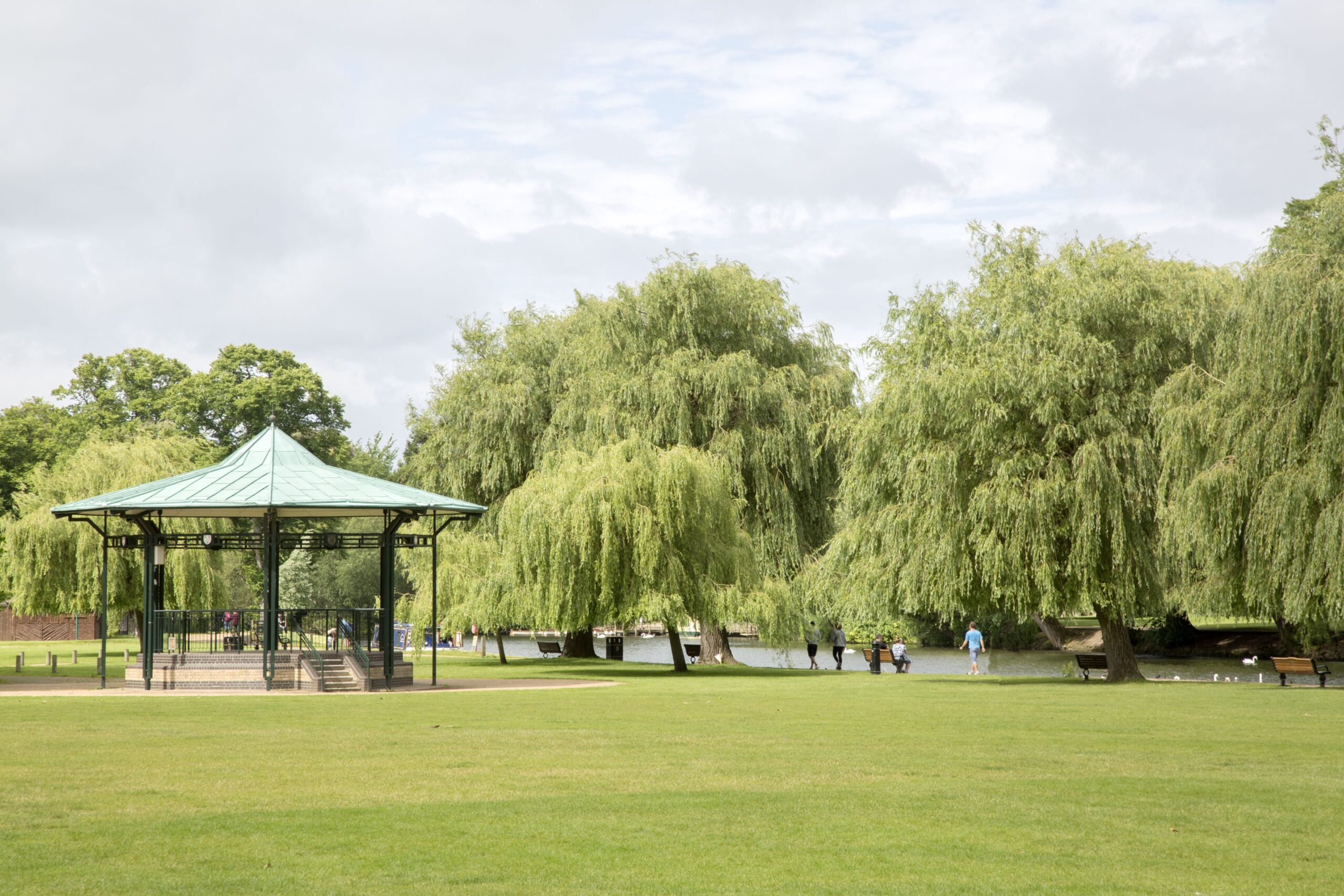 Park area with willow trees and a gazebo