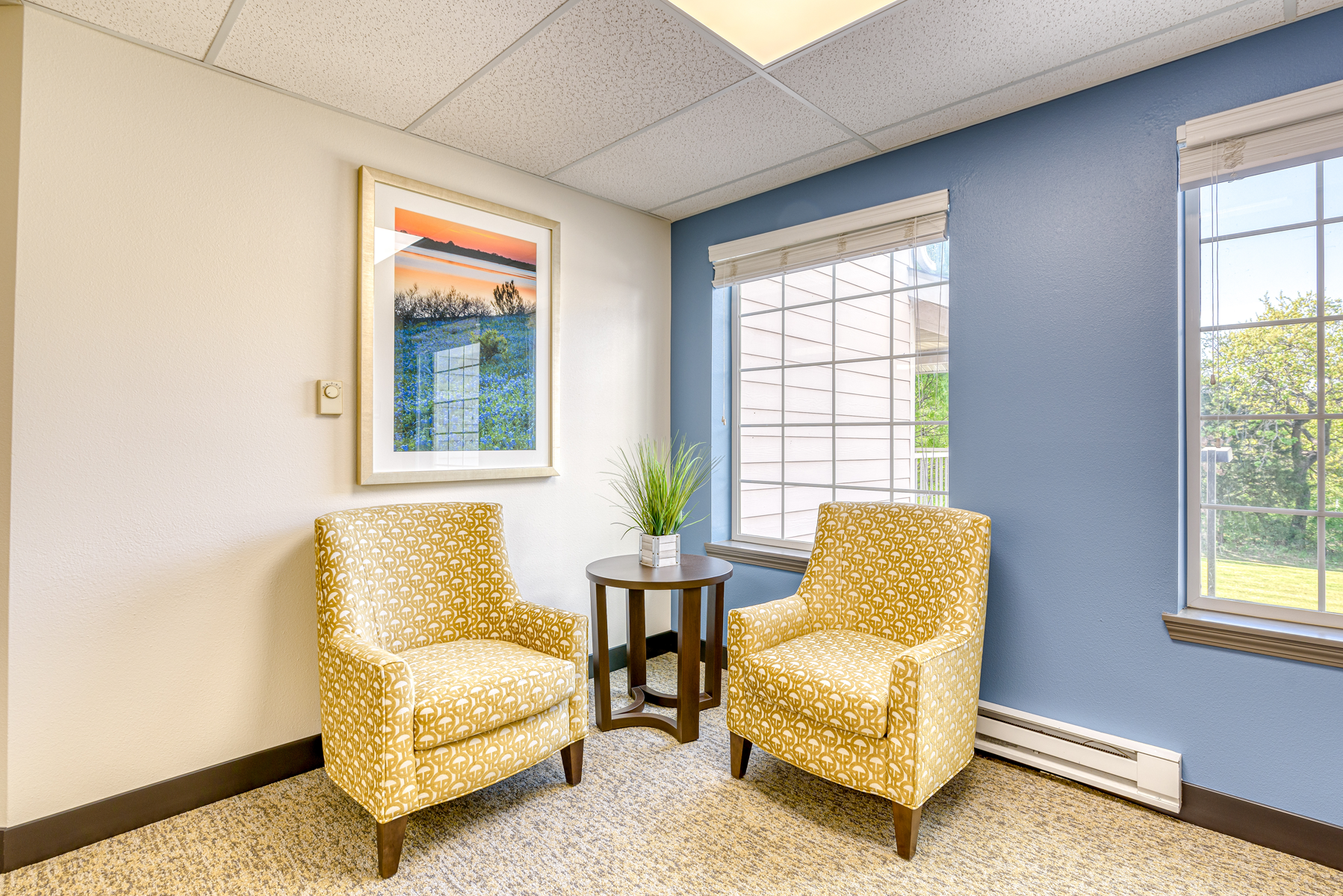 Cozy lounge area with two chairs and artwork