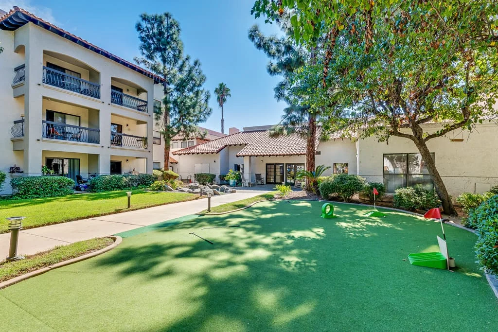 Outdoor putting green with facility building in background