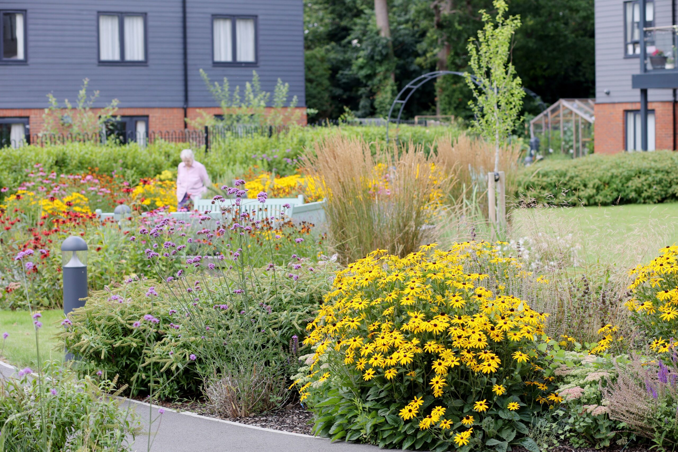 Resident enjoying the gardens at Woodbank Apartments.