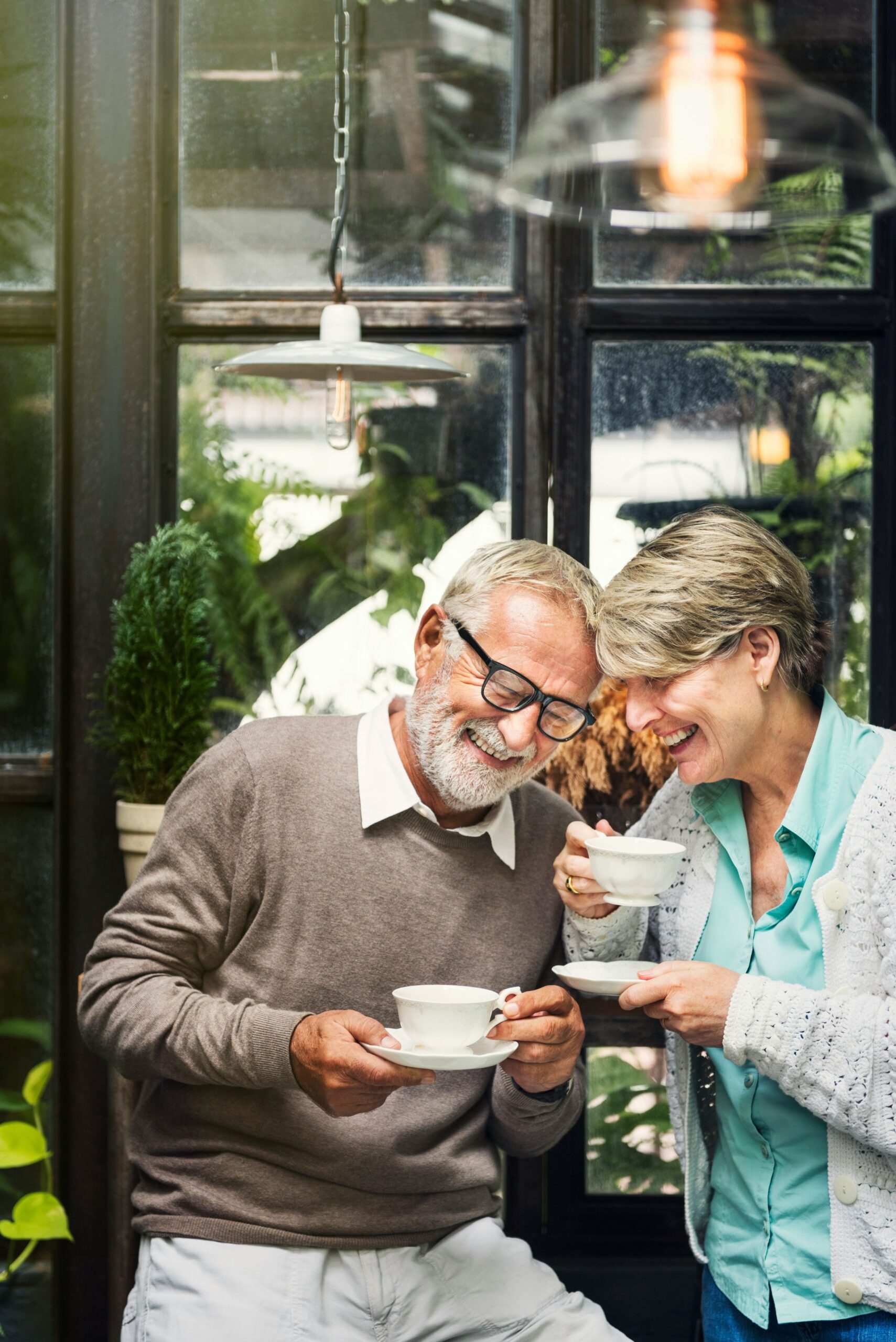 Two seniors enjoying tea in a cozy setting