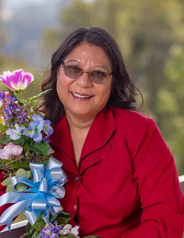 Resident smiling while holding flowers