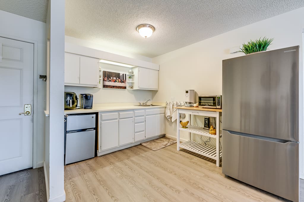 Bright kitchen area with appliances and countertop