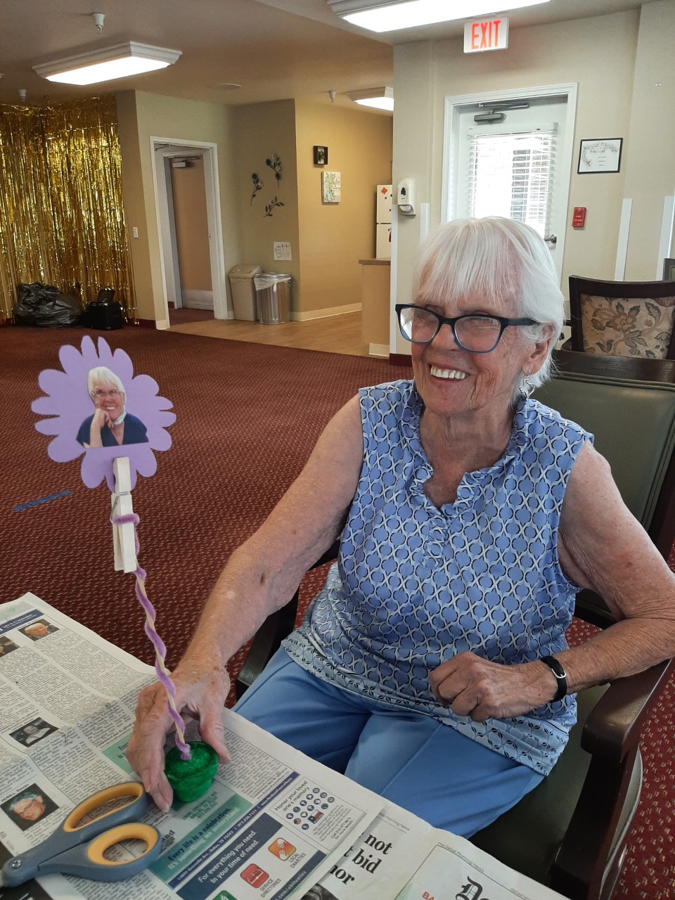 Resident crafting a floral decoration in the activity room