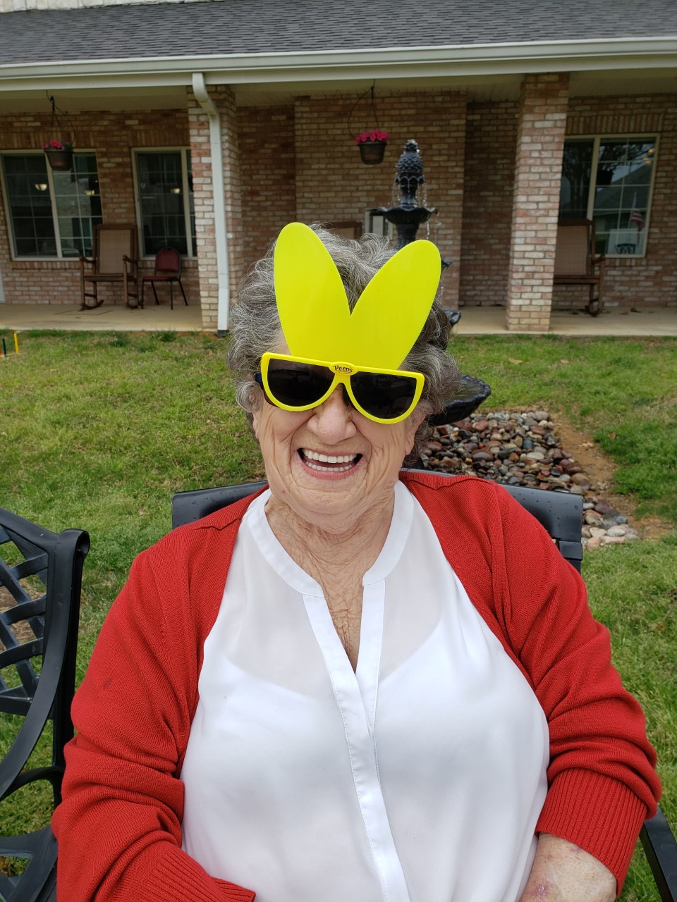 Senior resident wearing fun oversized sunglasses outdoors