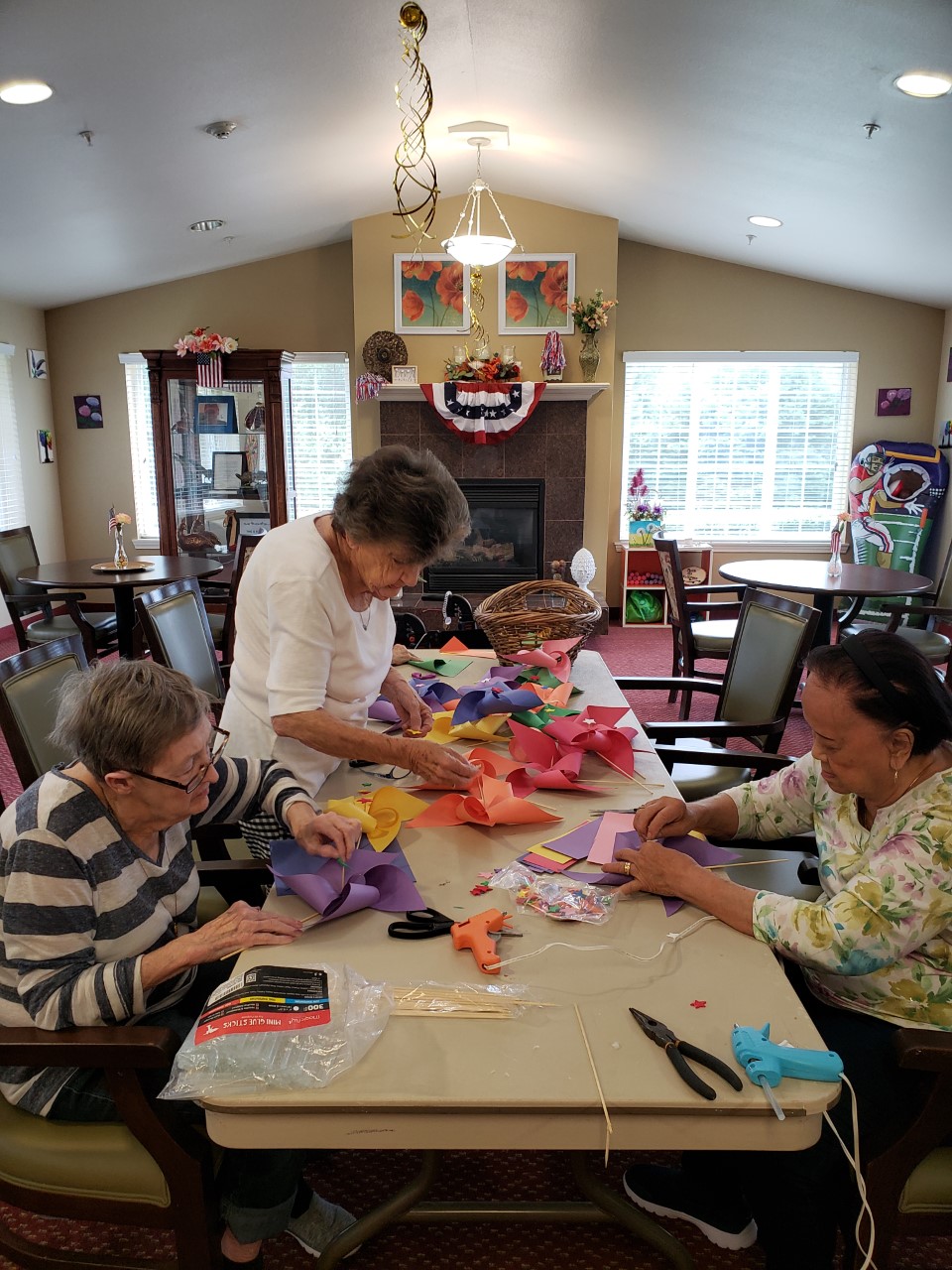 Residents engaging in craft activity in a common area