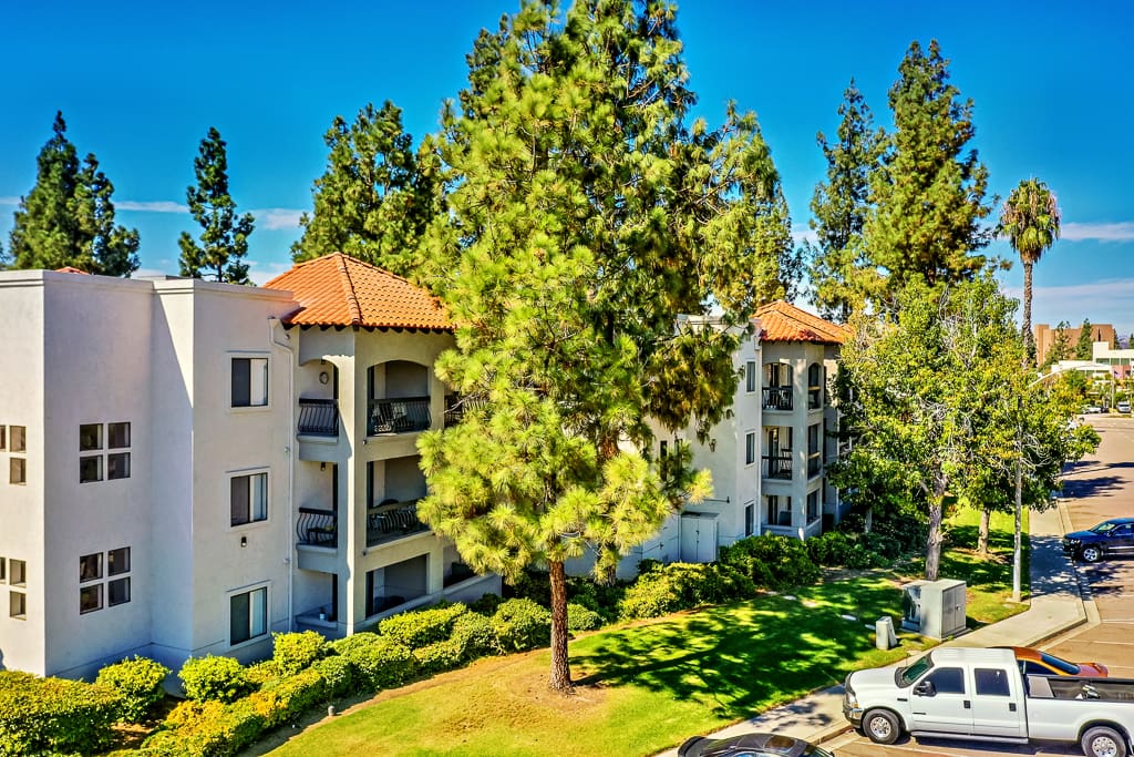 Exterior view of the senior living facility surrounded by trees