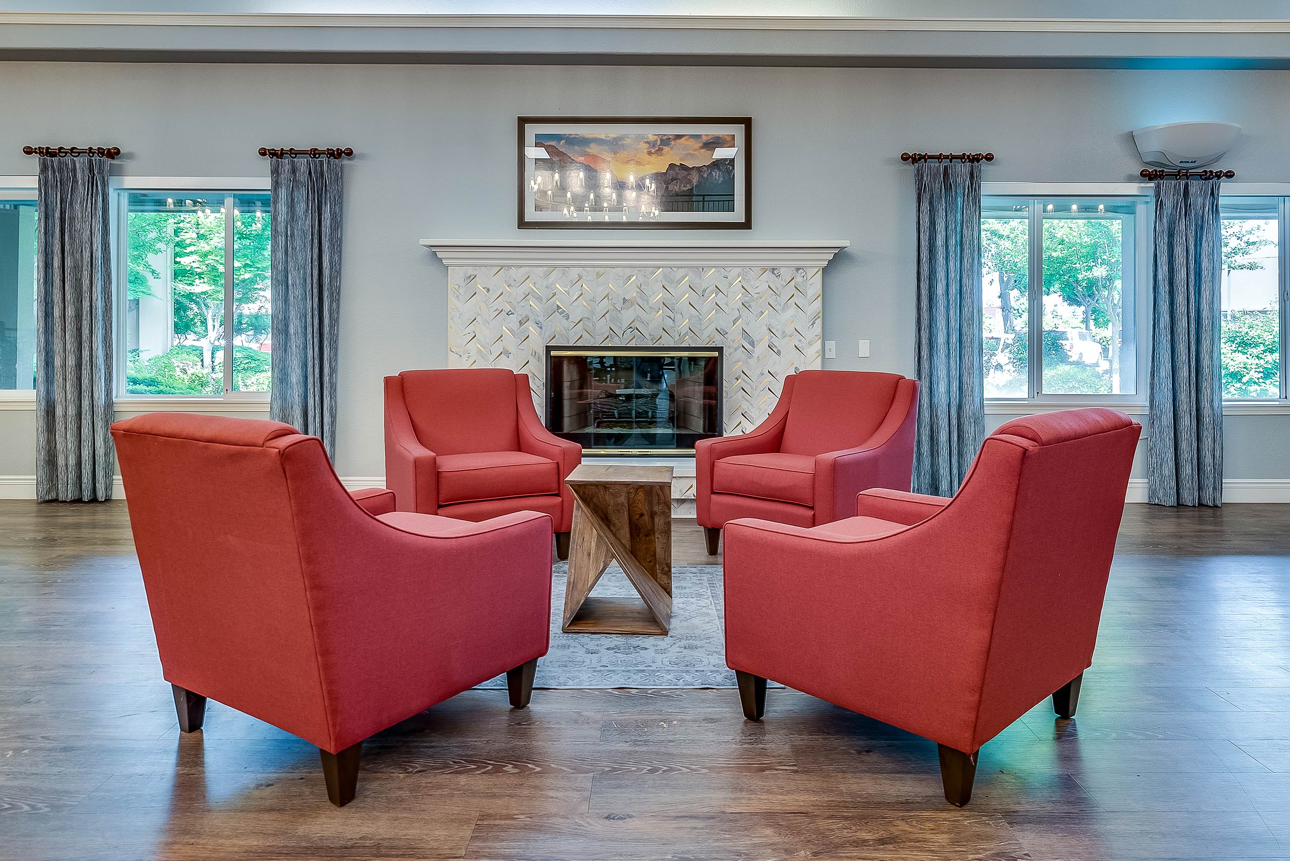 Cozy common area with red armchairs and a fireplace