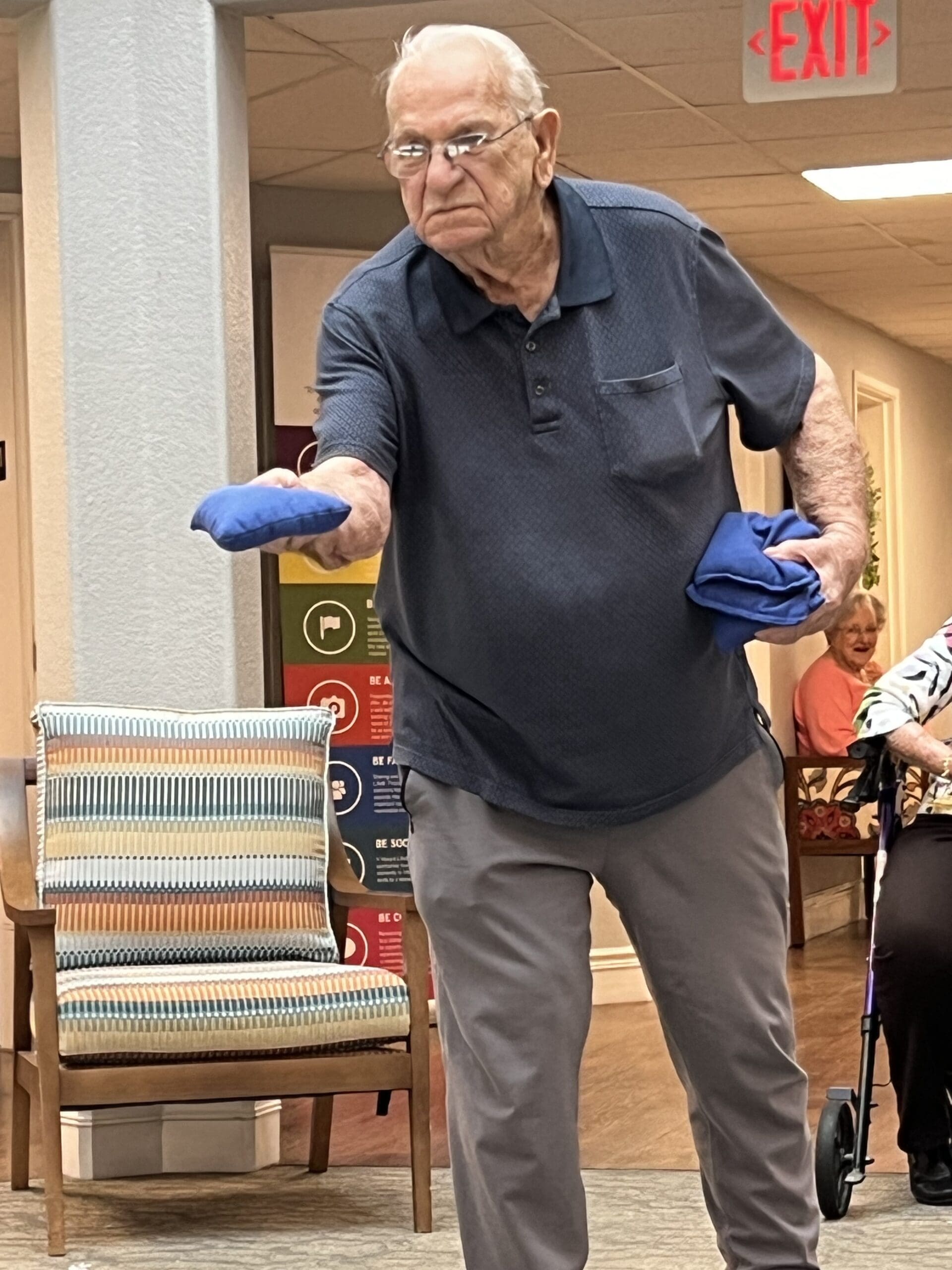 An elderly man participating in an indoor activity