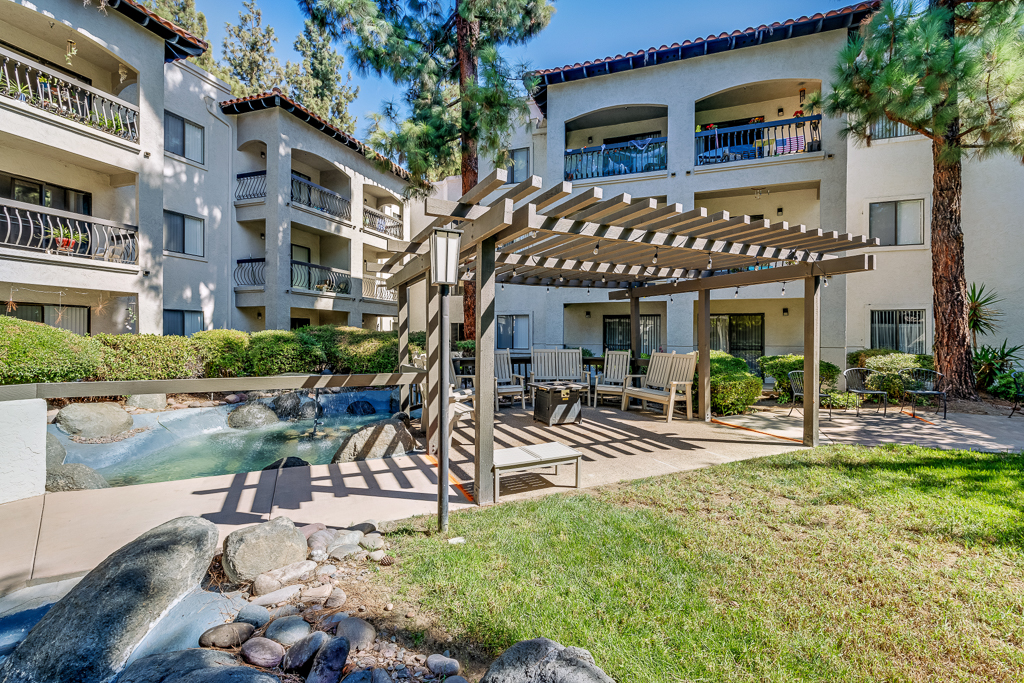 Outdoor seating area with pergola and greenery