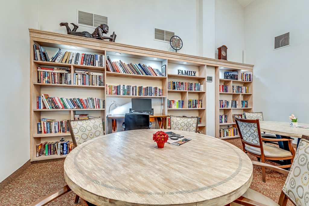 Cozy common area with bookshelves and a dining table