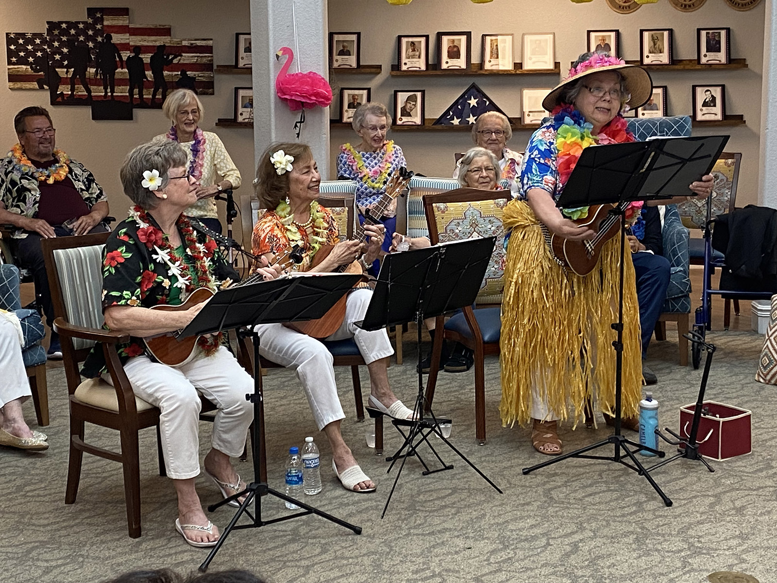 Residents performing music with ukuleles in a common area
