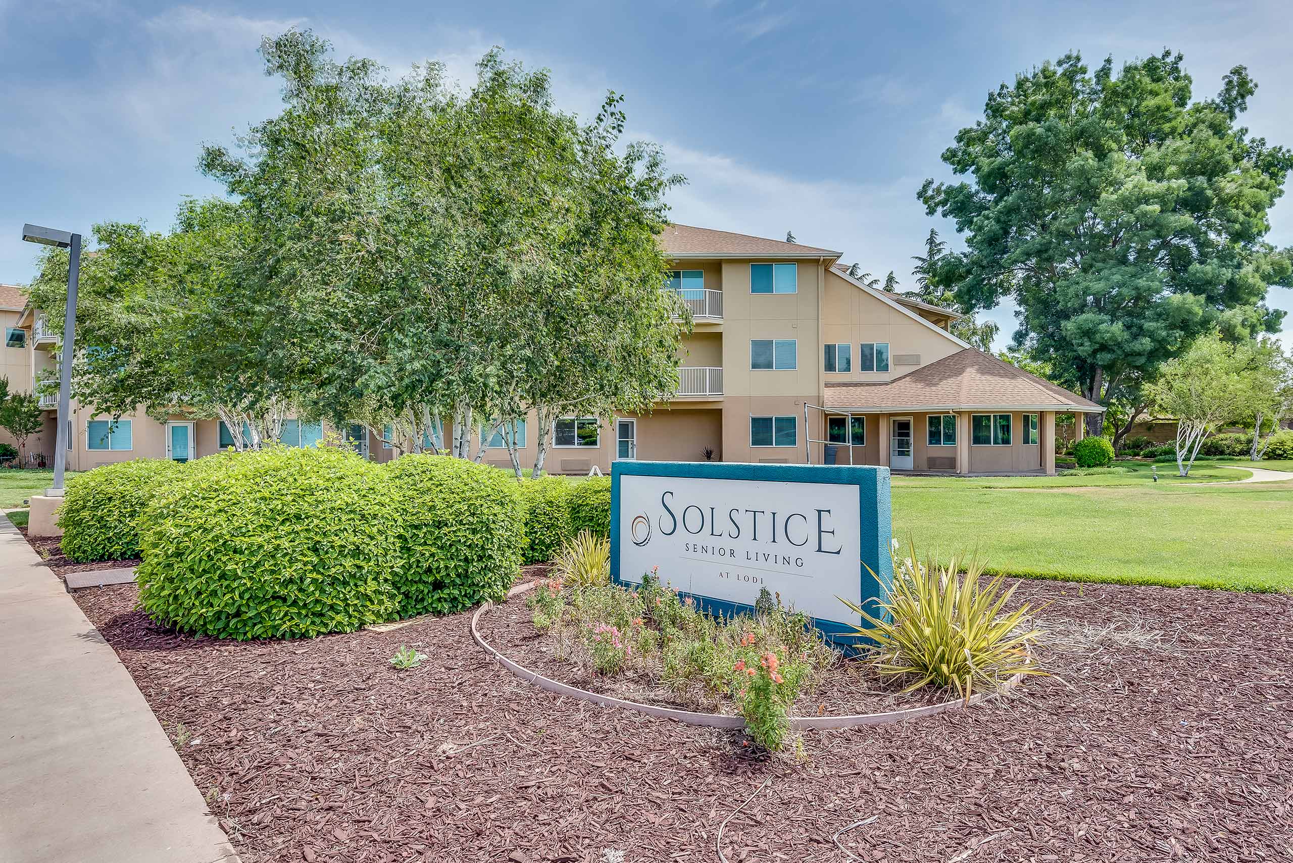 Exterior view of Solstice Senior Living with landscaped grounds