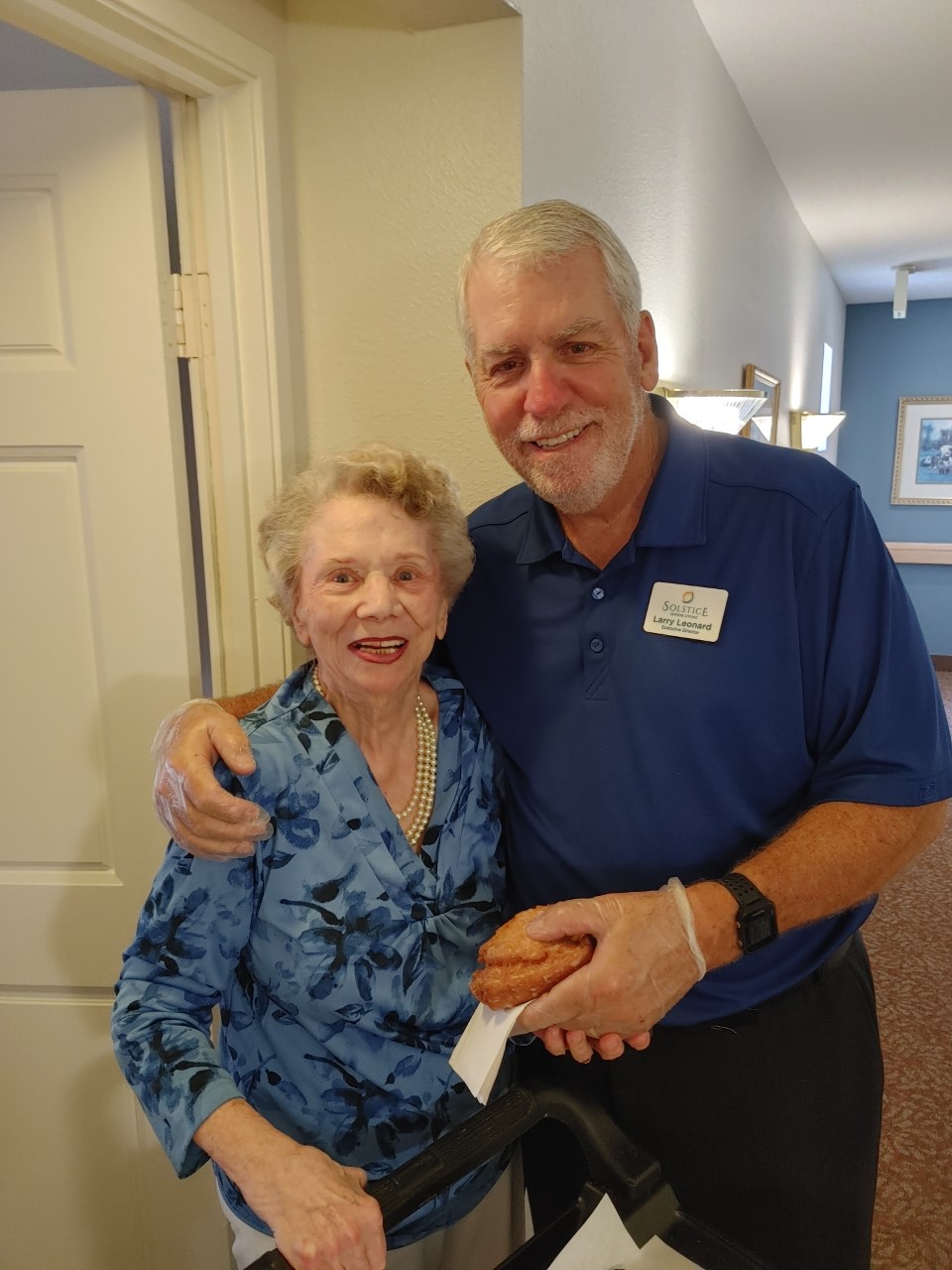 Resident and staff member sharing a joyful moment indoors
