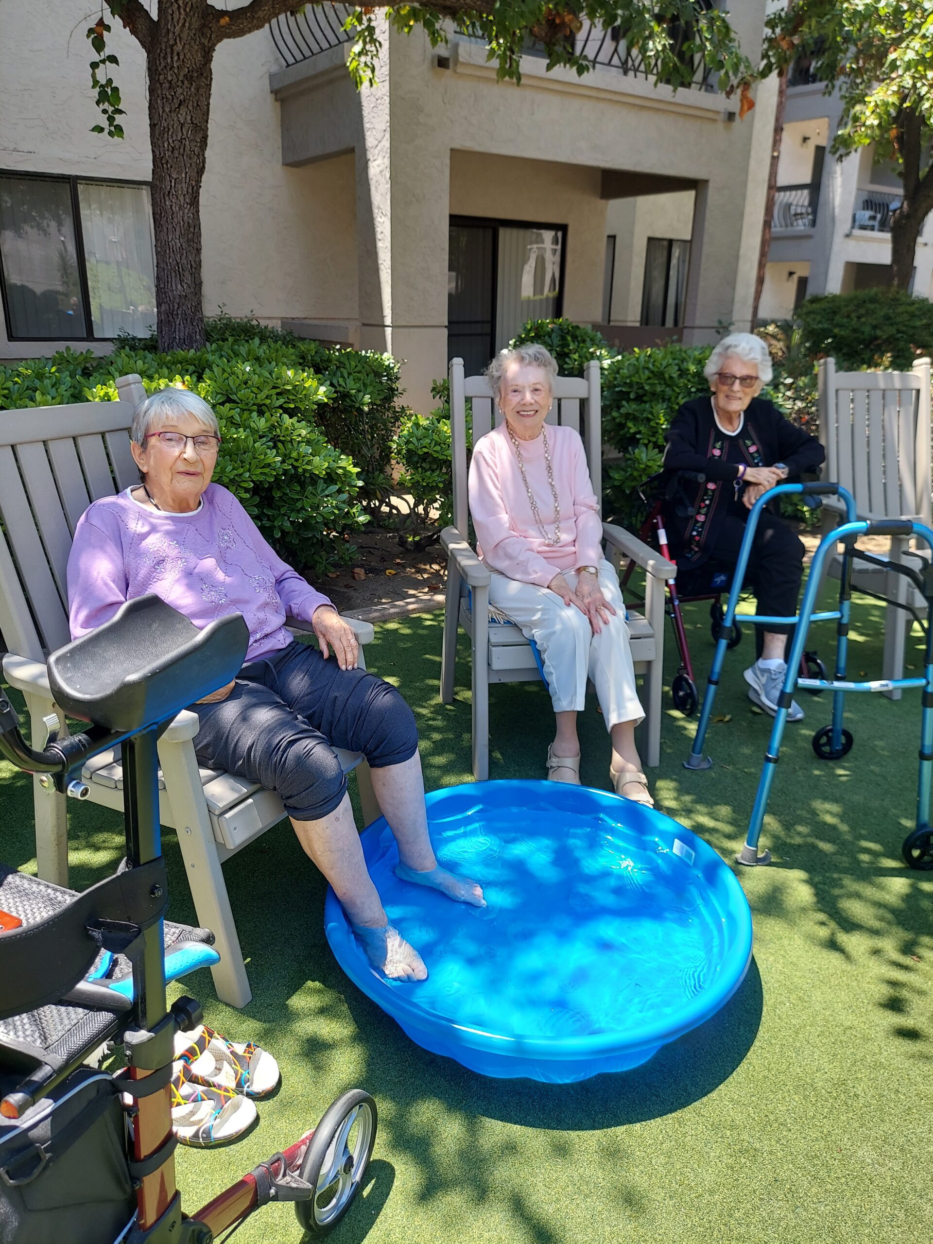Three residents enjoying a pool on a sunny day