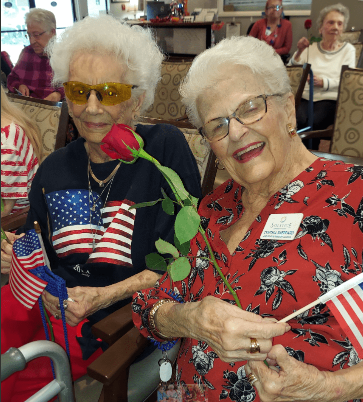 Residents enjoying an activity with flags and flowers