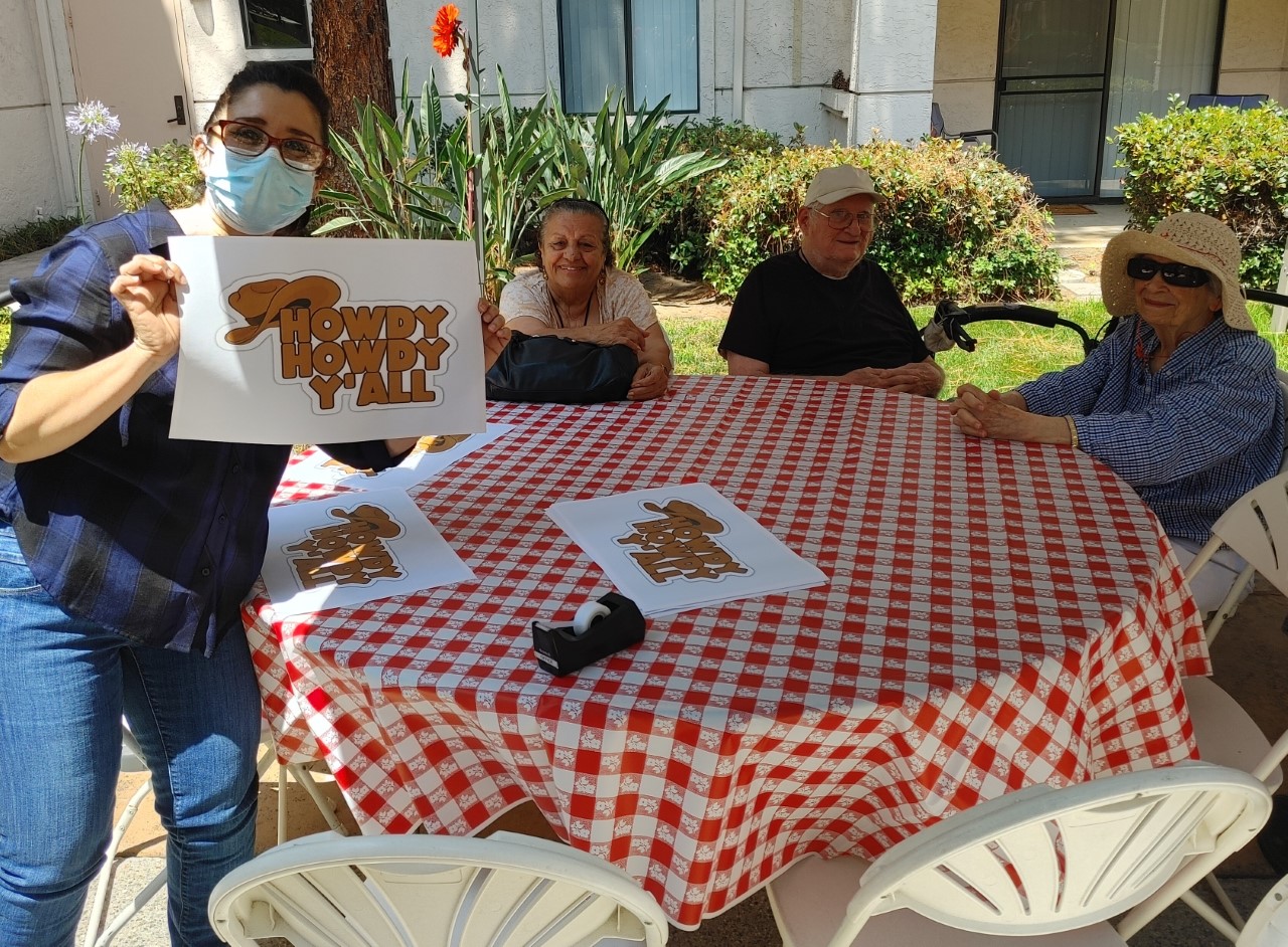 Residents and staff interacting outdoors with decorations