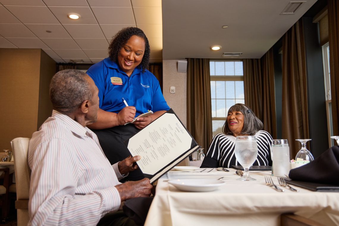 Resident enjoying meal service in dining area