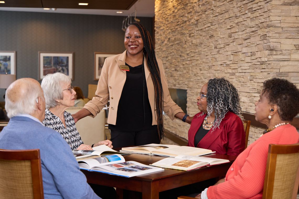 Residents engaging with staff in a social setting