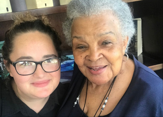 Staff member smiling with a resident in a common area