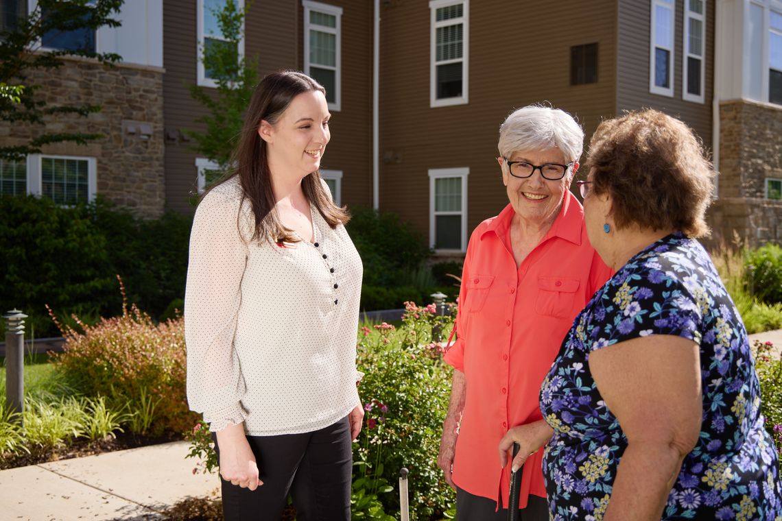 Staff and residents interacting in a garden area
