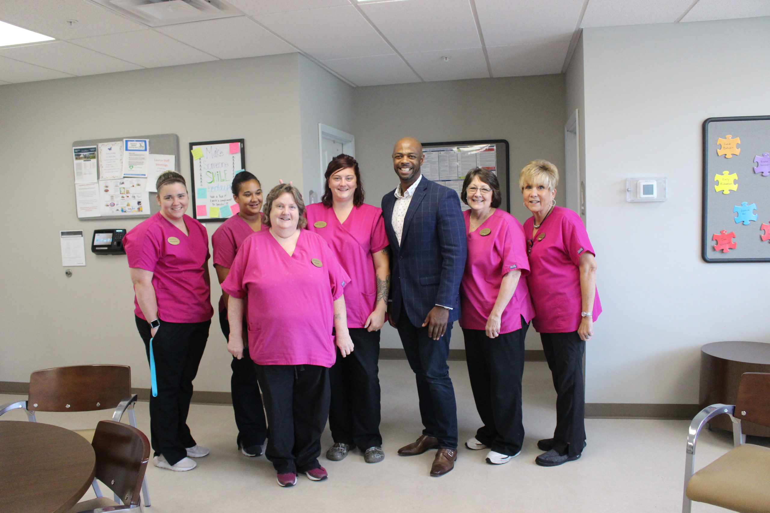 Staff members posing together in a common area