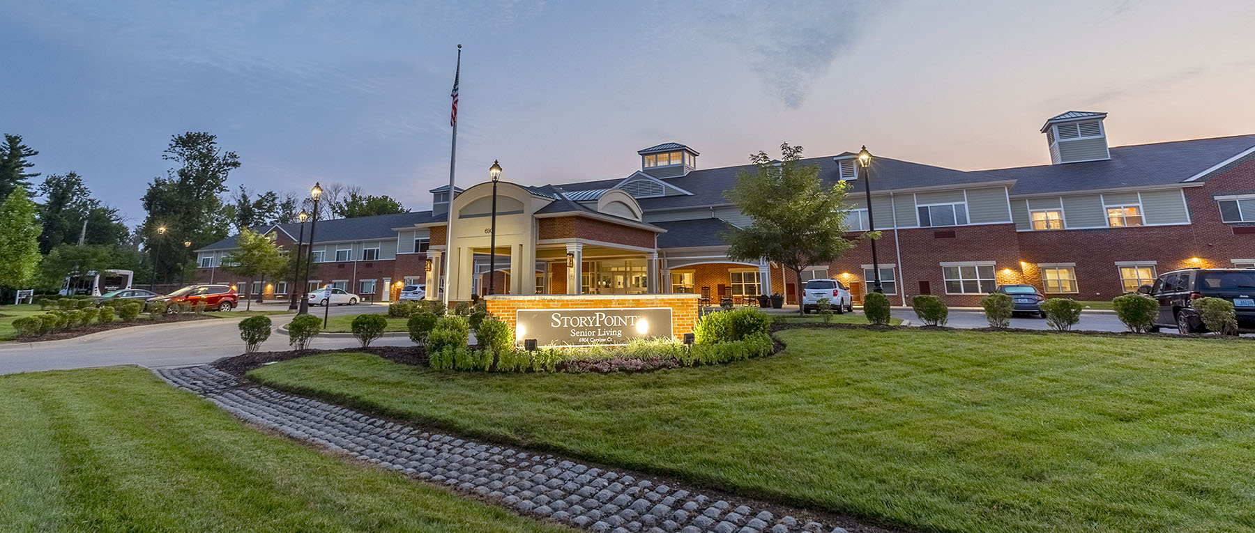 Exterior view of the senior living facility at twilight