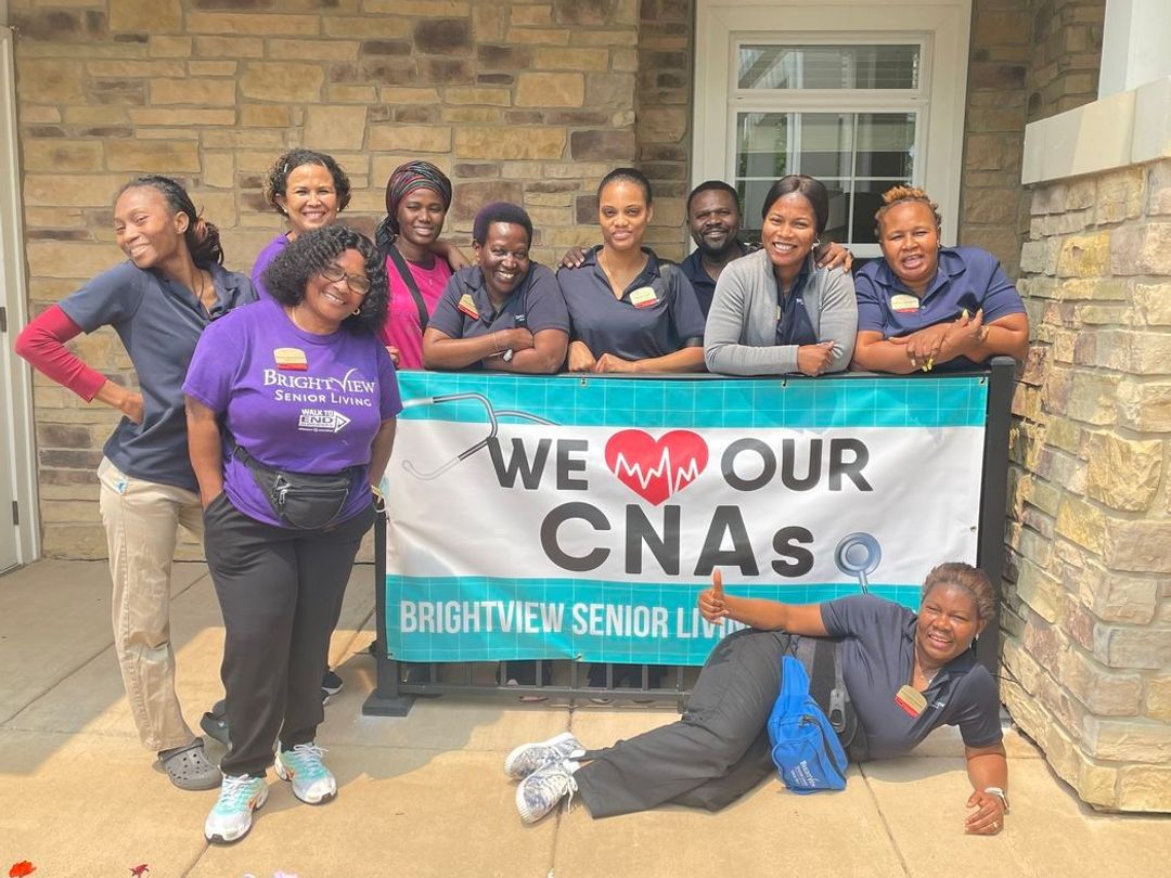 Staff celebrating their appreciation for CNAs with a banner