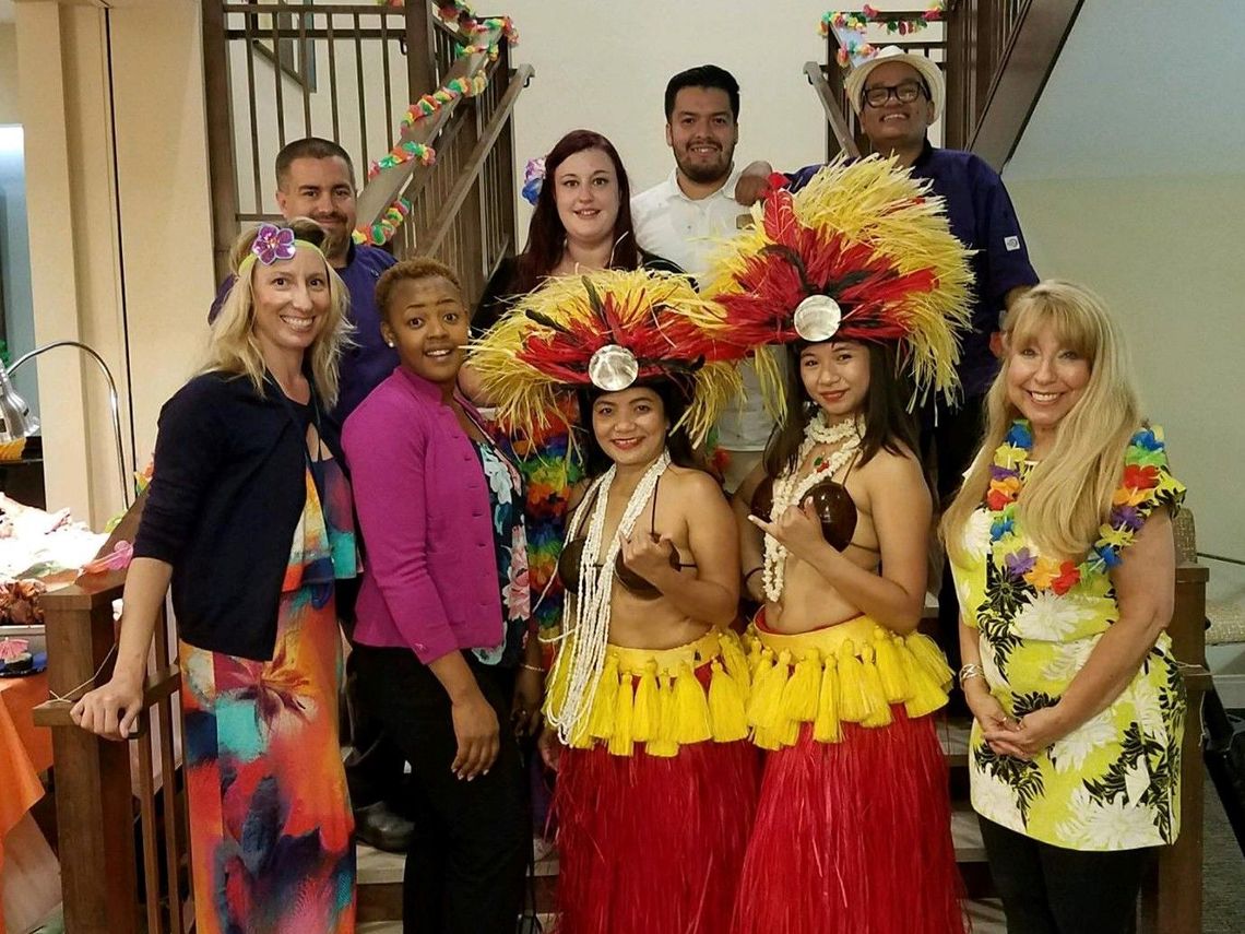 Staff and residents celebrating with Hawaiian-themed attire