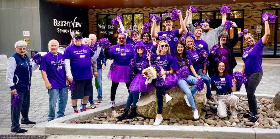 Residents and staff celebrating outside the facility