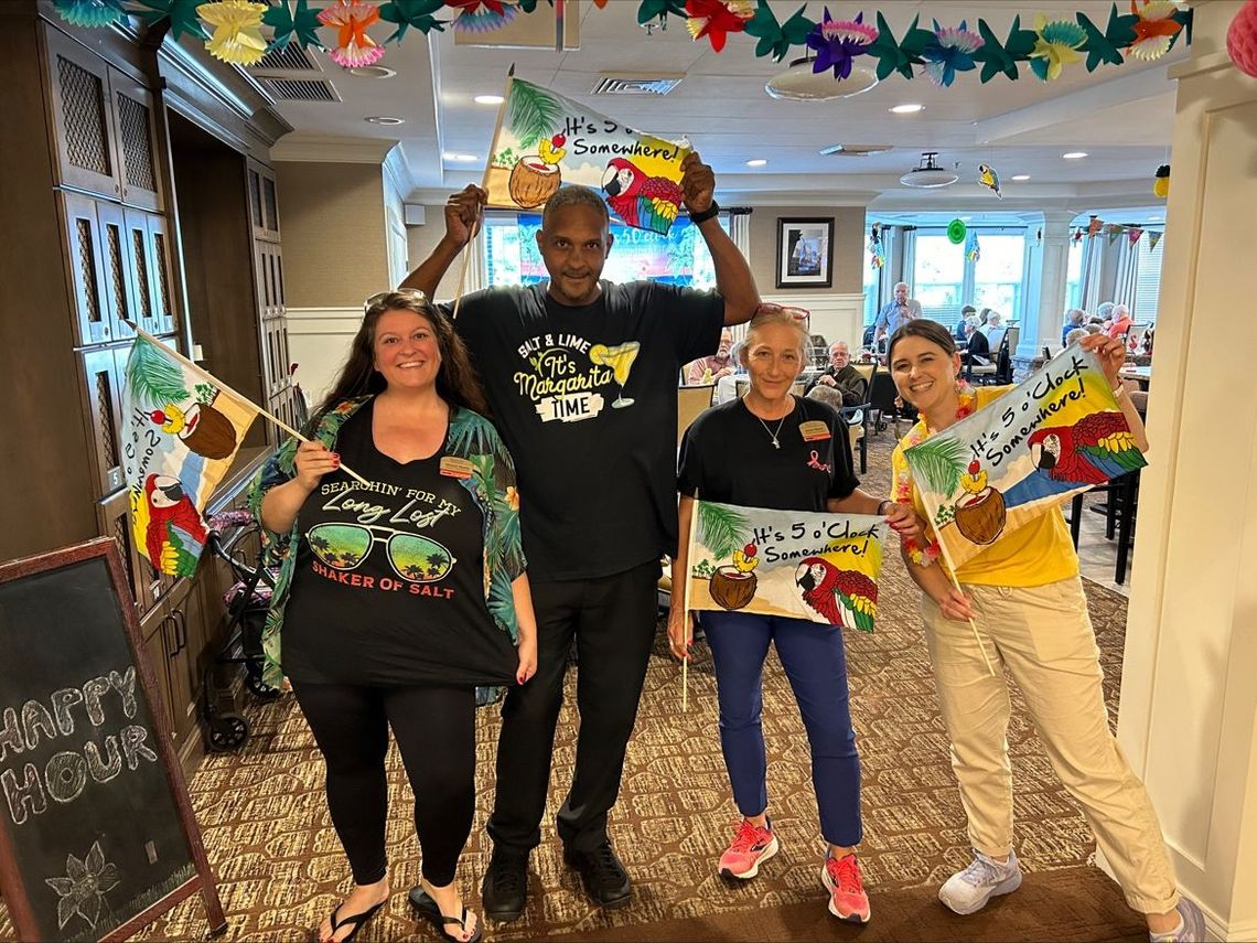 Staff and residents celebrating with colorful decorations