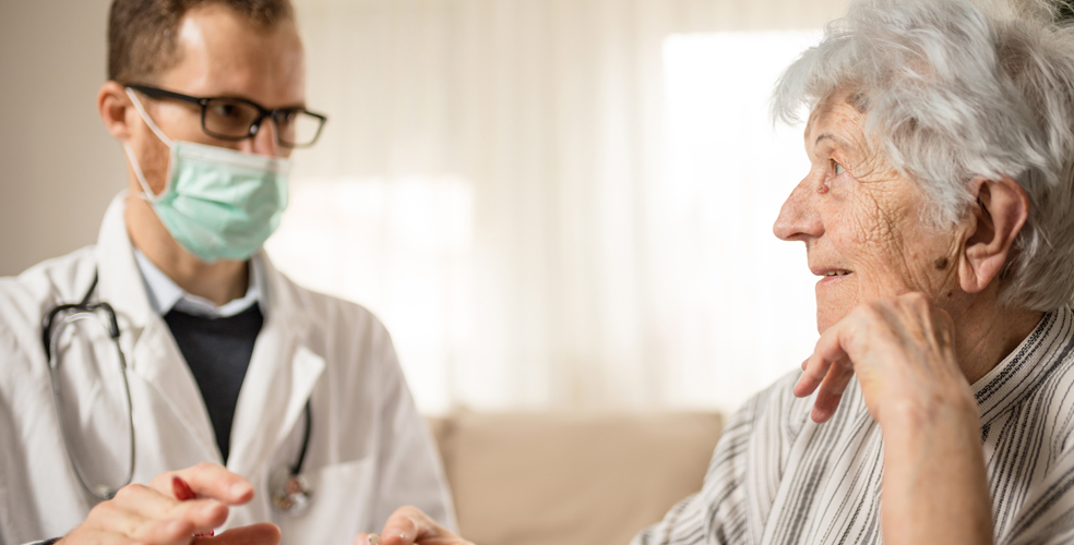 Healthcare professional interacting with elderly resident