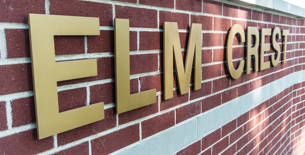 Close-up of Elm Crest building signage