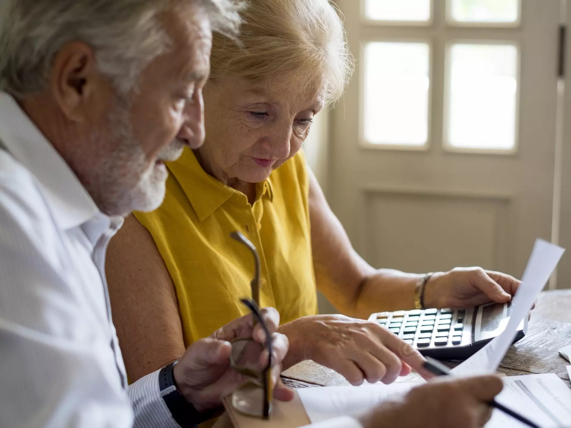 Two seniors reviewing documents at a table