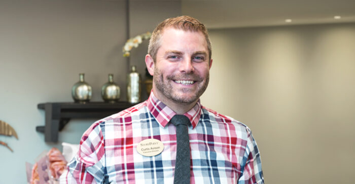 Staff member smiling in a facility interior