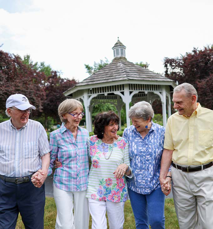 Residents enjoying time together outside by a gazebo