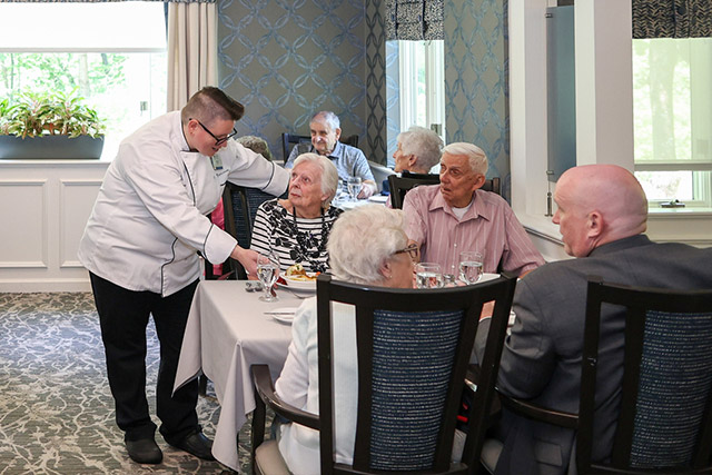 Residents dining together in a cheerful lunch setting