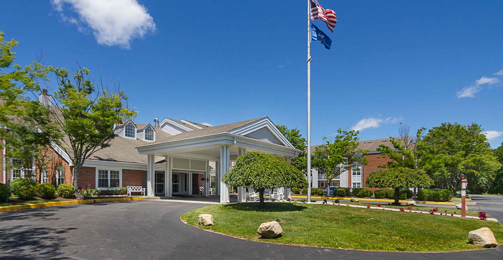 Exterior view of the senior living facility with gardens