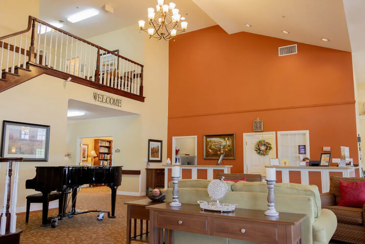 Bright lobby area with piano and seating