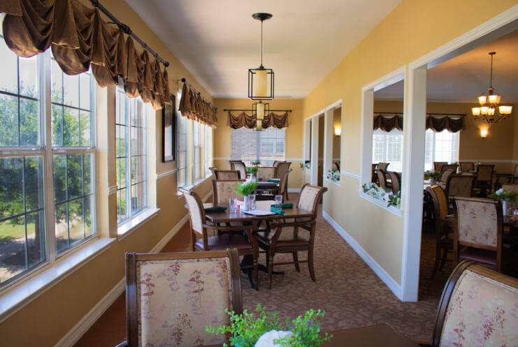 Bright dining area with large windows and tables
