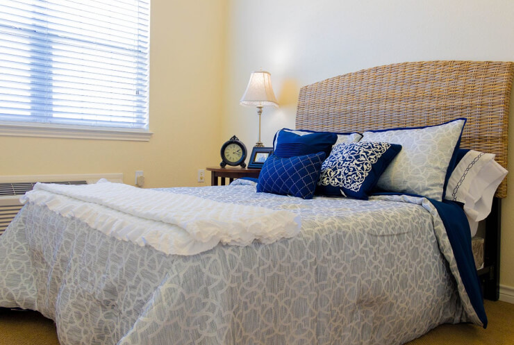 Cozy bedroom with decorative pillows and lamp