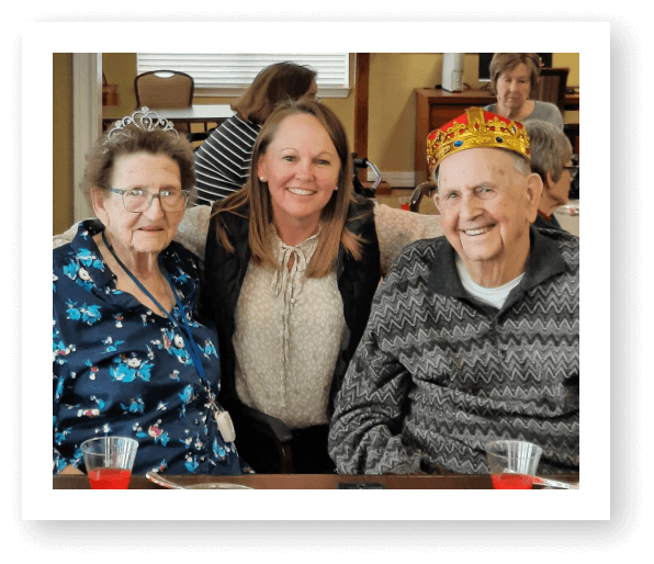 Residents celebrating with staff in a common area.